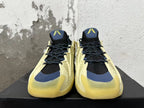 Front view of cream and black basketball sneakers with navy accents and translucent yellow toes