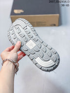 Close view of the sandal outsole showing a deep repeating tread pattern and a central molded detail.