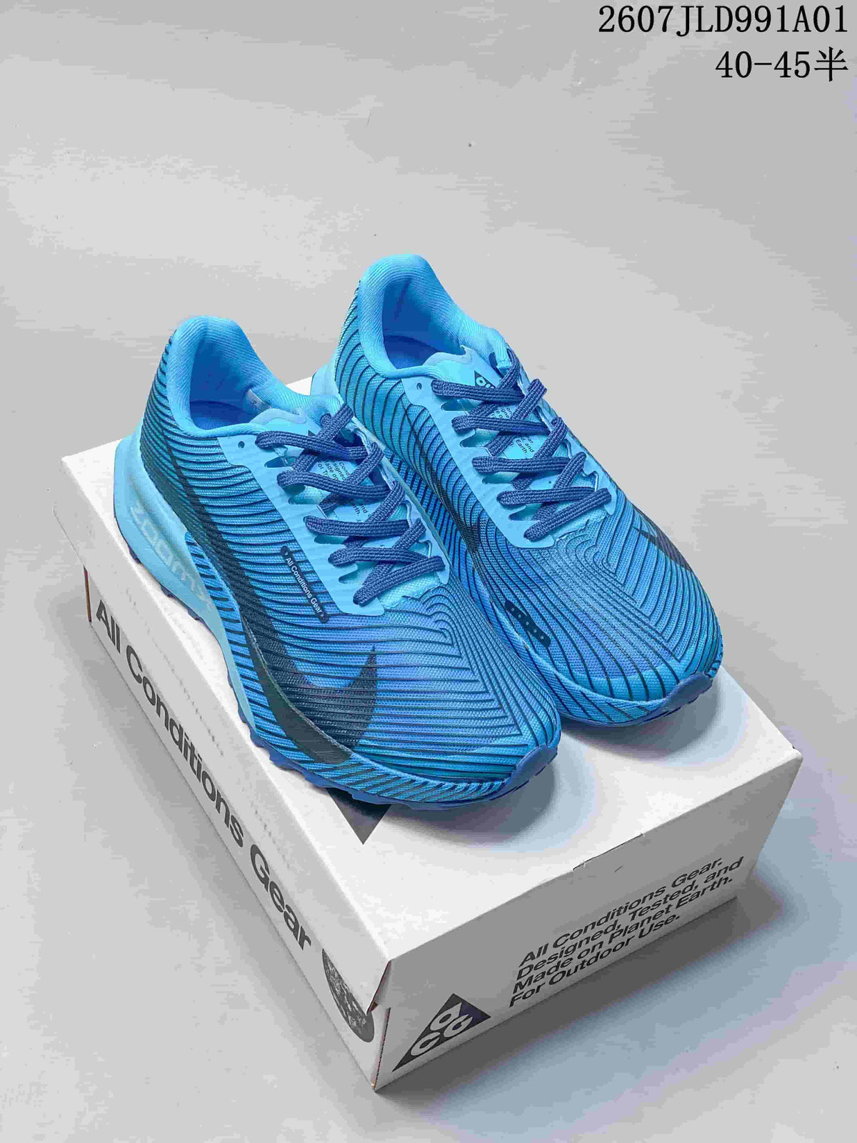 Pair of blue Nike ACG trail shoes with dark accents