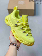 Angled side view of the neon yellow On x LOEWE sneaker showing the lace hardware, heel cushioning channels, and treaded outsole.