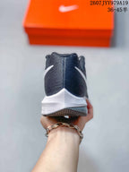 Rear view highlighting the dark gray knit-style heel and white midsole of the sneaker.