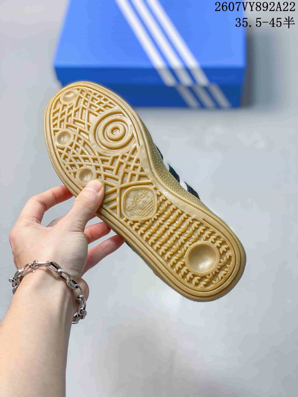 Close-up of the gum-colored outsole showing its textured tread pattern and adidas branding.