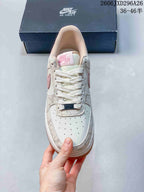 Top view showing the perforated toe, white laces, and pink tongue label