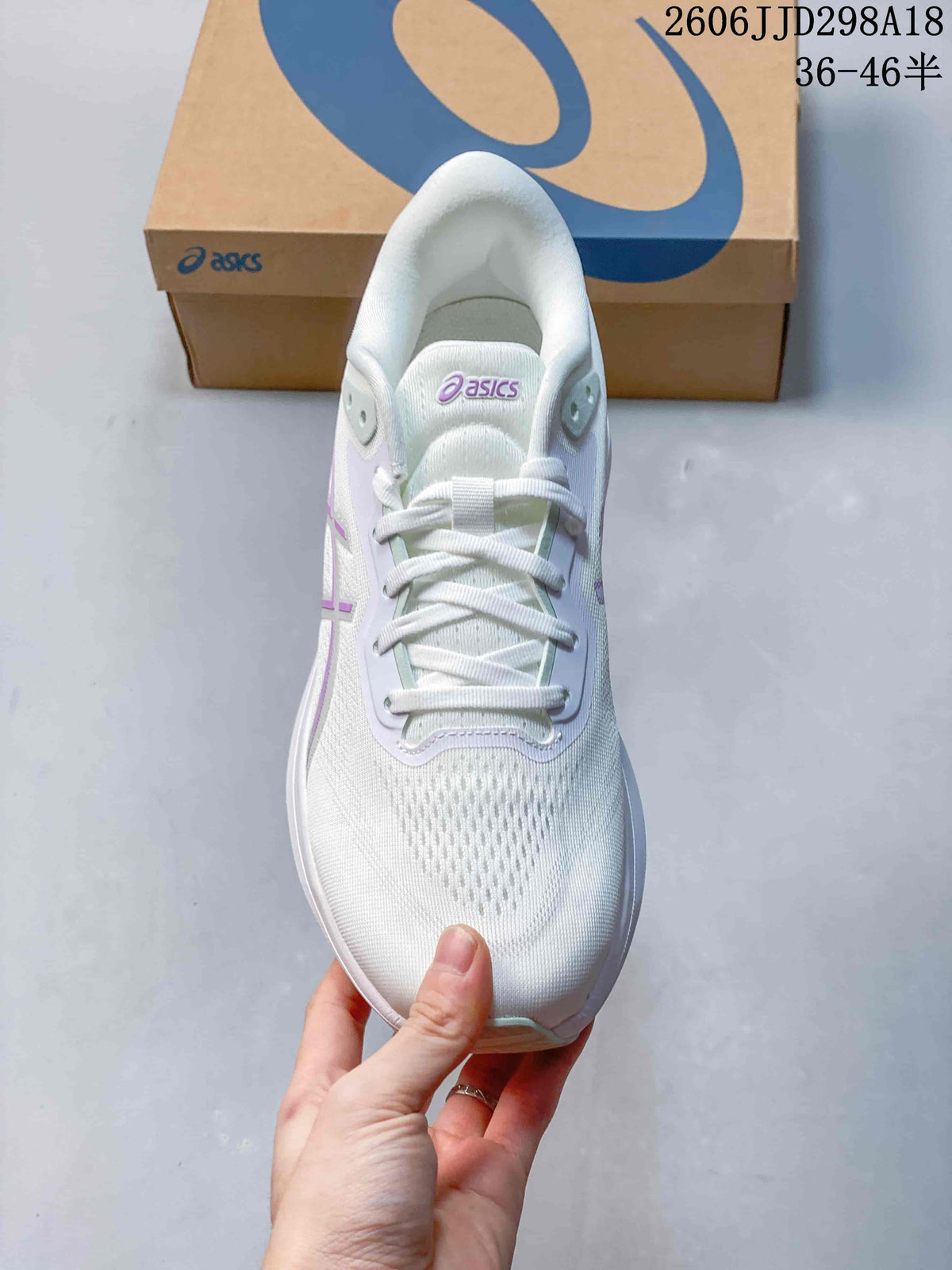 Top view of the ASICS running shoe showing the mesh-like toe area, tongue and white laces.