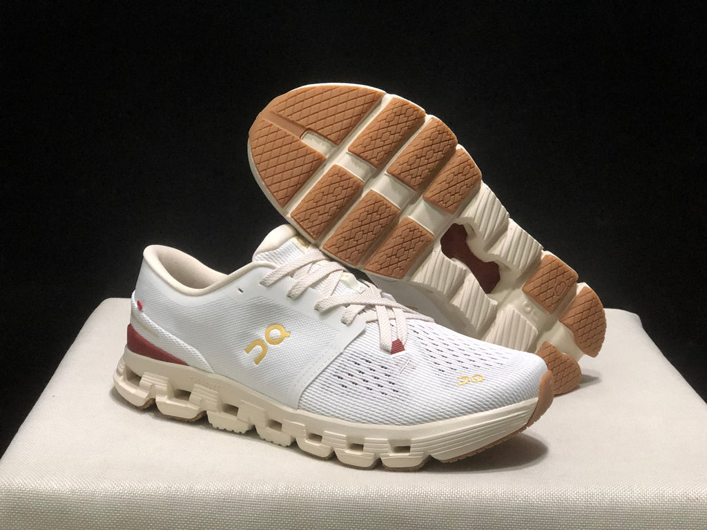 White On Cloud X4 shoe shown from above with the outsole exposed, including tan textured traction sections.