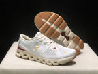 White On Cloud X4 shoe shown from above with the outsole exposed, including tan textured traction sections.