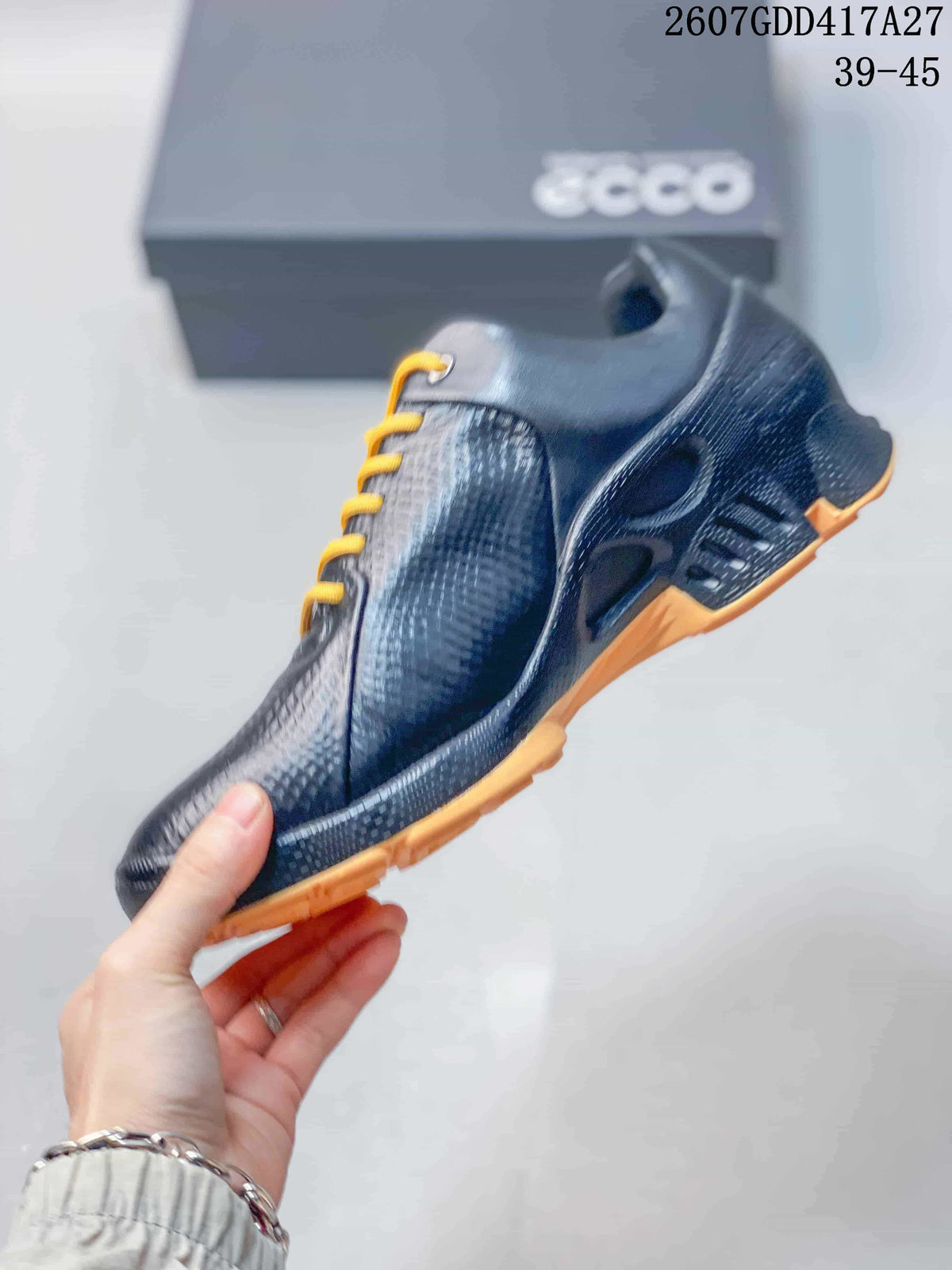 Side view of the black lace-up sneaker showing its textured upper, molded side details, and tan outsole.