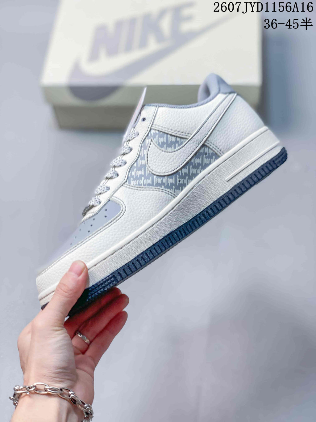 Side view showing the white Nike Swoosh, patterned side panel, blue-grey toe area and low-top construction.