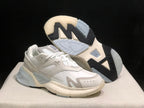AMIRI MA Runner sneakers shown from the side with one shoe lifted to reveal the contrast outsole.