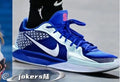 Blue and white Nike high-top basketball shoe with blue laces, white side Swoosh, and pink number 6 on the tongue