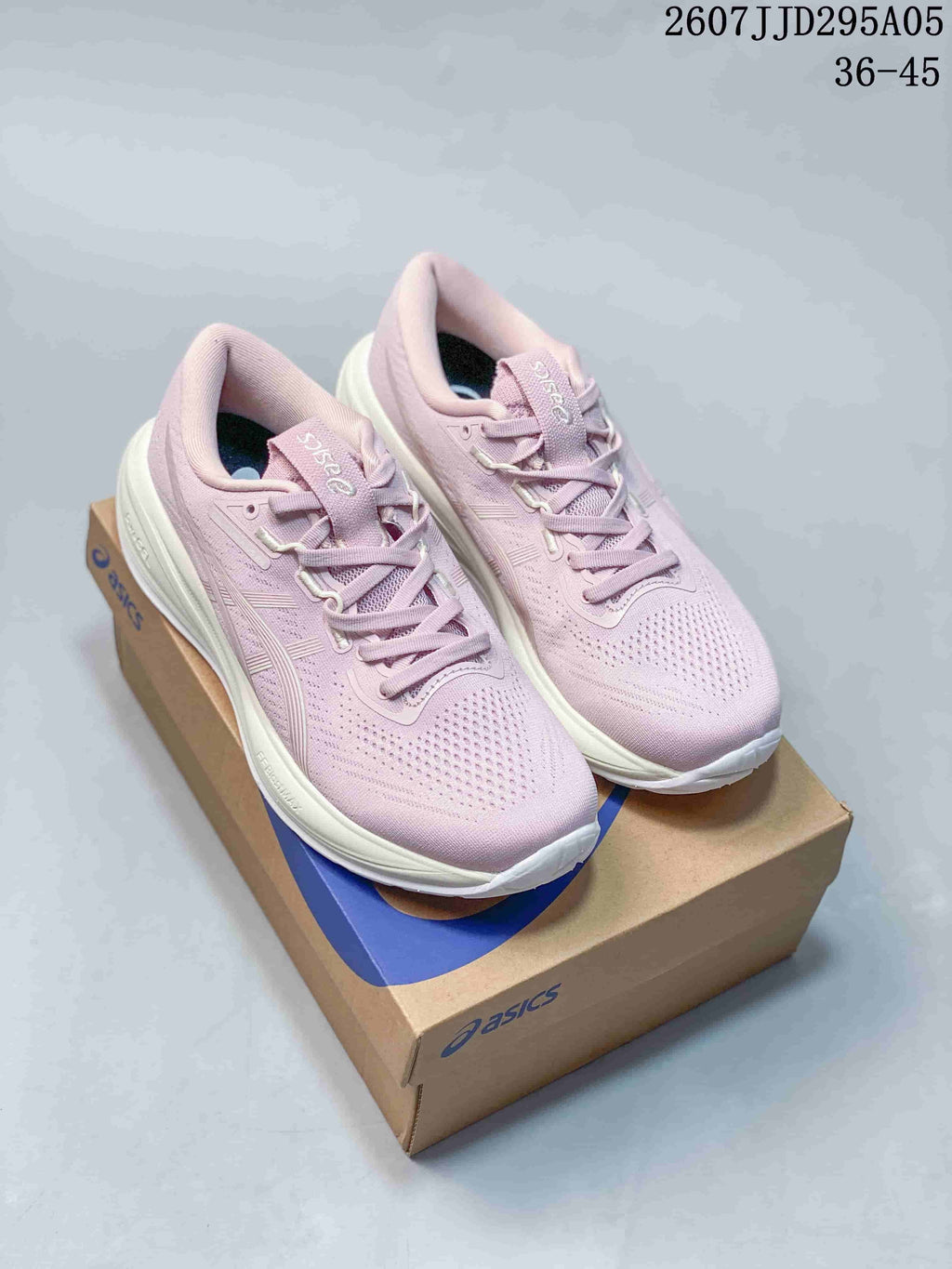 Pair of pink and white ASICS Gel-Cu sneakers displayed on an ASICS shoe box; image shows style code 2607J TD295A05 and size range 36–45.