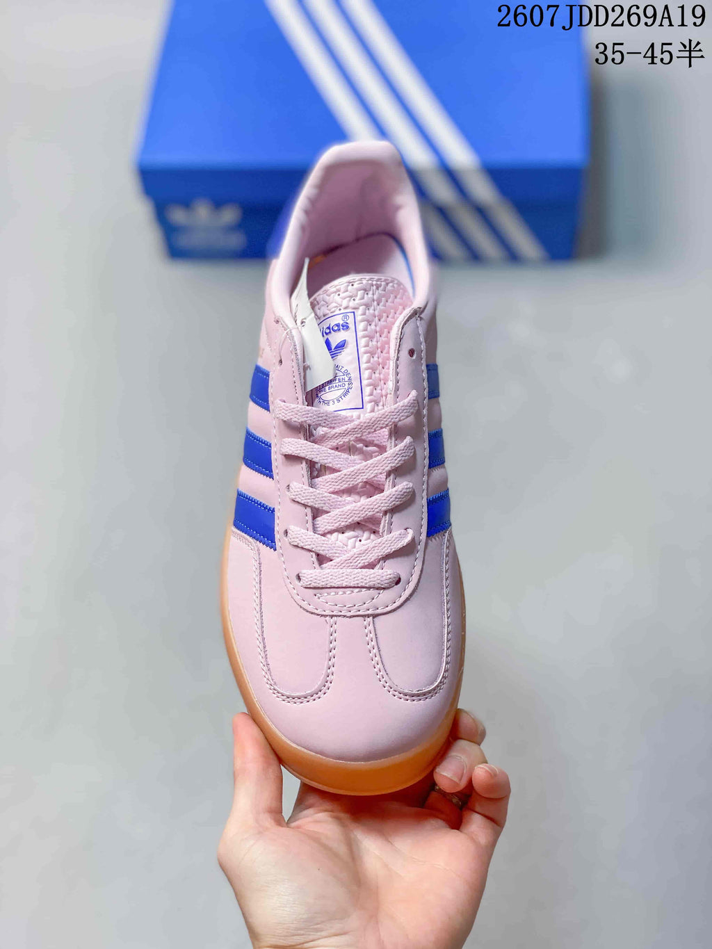 Top view showing the pink laces, tongue label, and rounded toe shape.