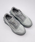 Top view of a pair of gray Alo Runner sneakers showing the lace arrangement, padded collars, and textured uppers.