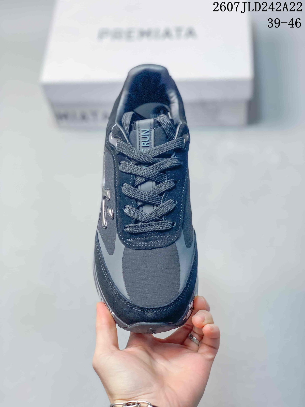 Top view of one dark navy and gray trainer showing the lace-up construction and RUN tongue label.