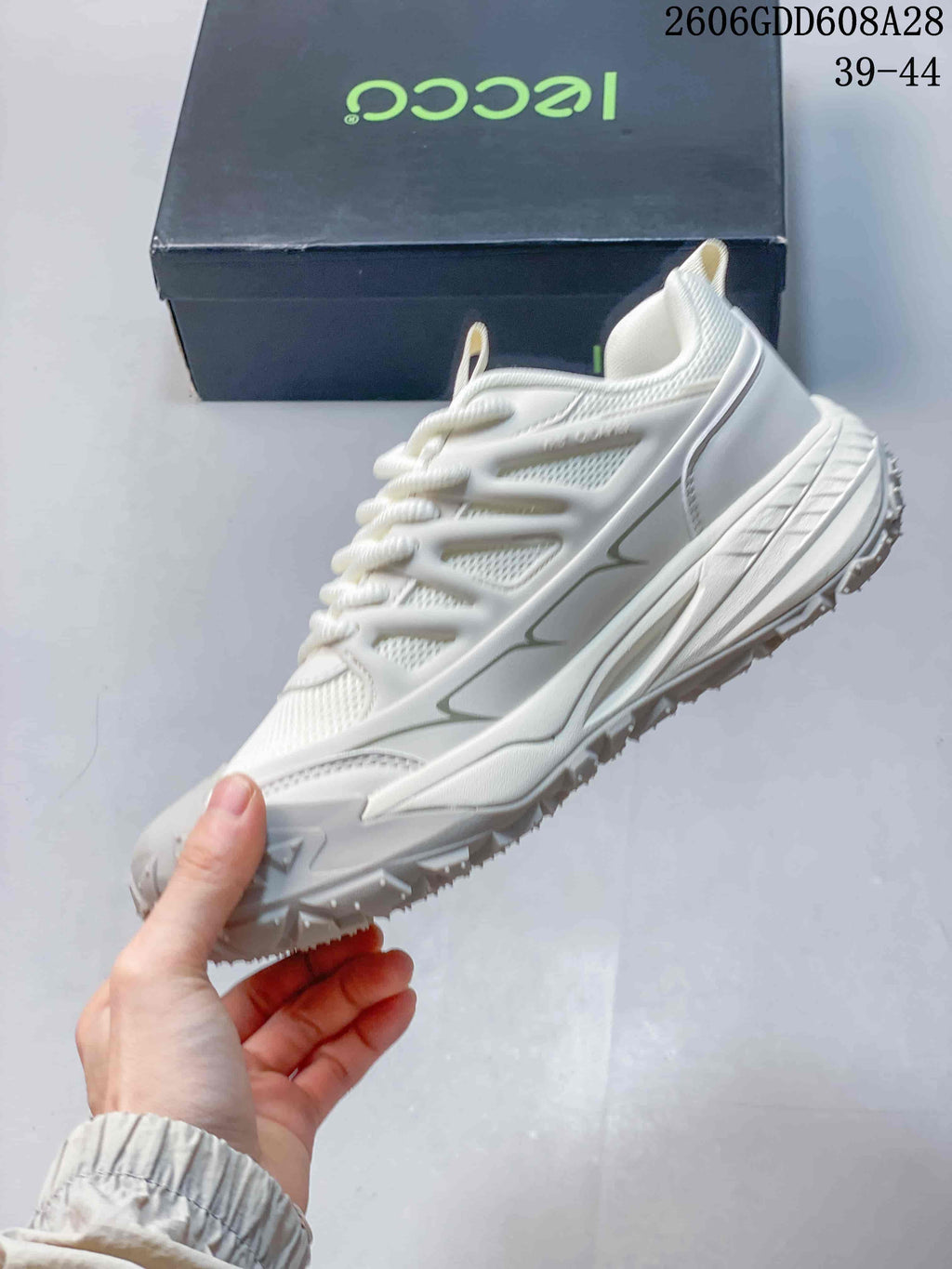 Side view of the white sneaker showing layered panels and chunky sole.