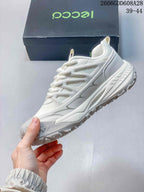 Side view of the white sneaker showing layered panels and chunky sole.