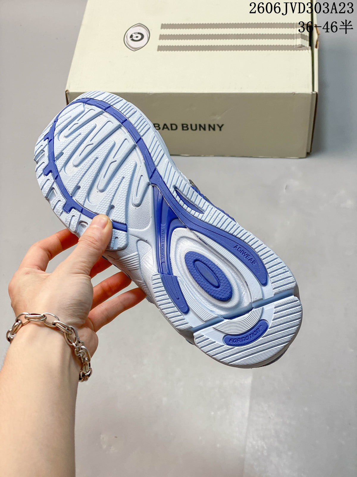 Underside of the sneaker showing a patterned white and blue outsole.