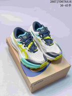 Pair of white ASICS trail running shoes with navy, lime, and turquoise details displayed on an ASICS shoebox; image text shows style code 2607JYD676A16 and size range 36–45.