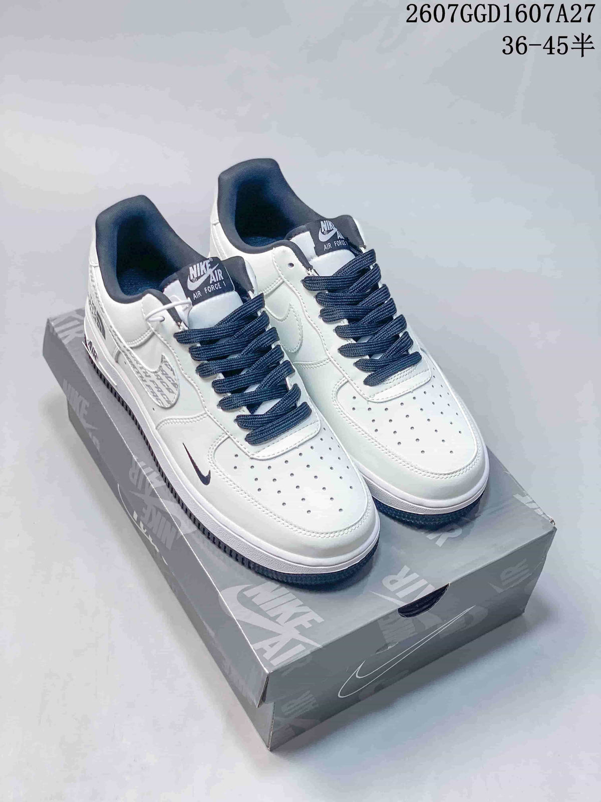 Pair of white and black Nike Air Force 1 Low sneakers displayed on a branded shoe box.
