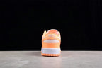 Rear view showing the orange heel, light gray heel panel, Nike branding, and rubber outsole.