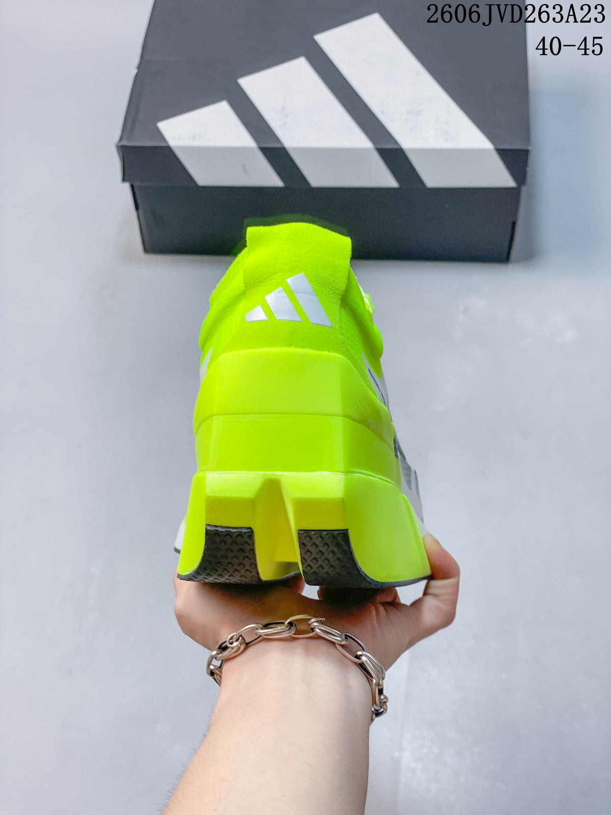 Rear view showing the neon-yellow heel and dark outsole sections.
