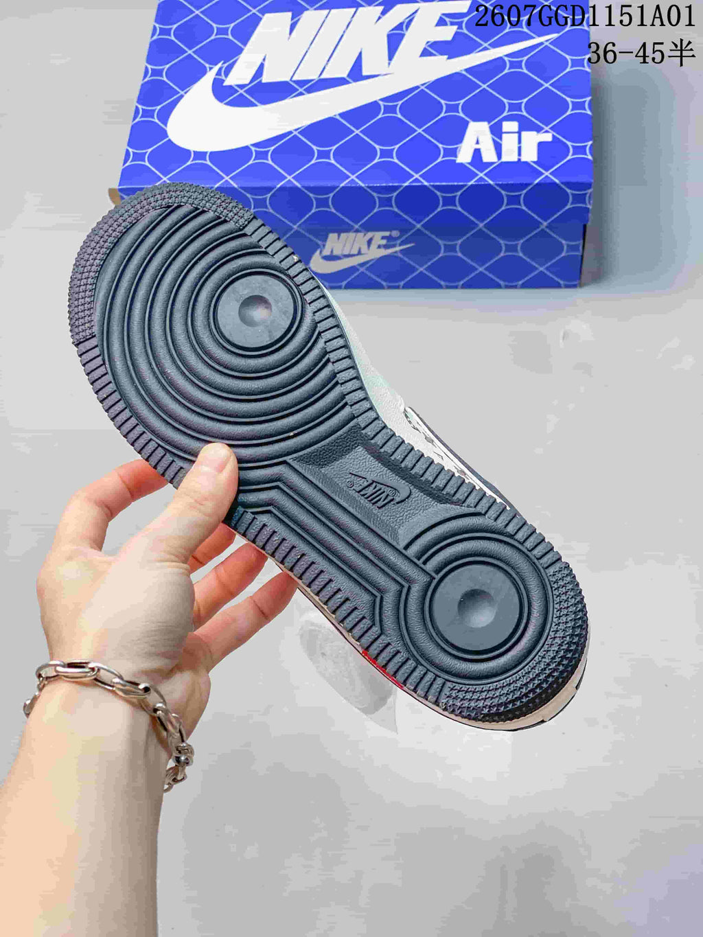 Close-up of the dark textured outsole and circular tread pattern.