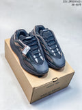 Pair of black Adidas Yeezy 700 sneakers with tan patterned side panels, displayed on a Yeezy 700 shoebox; size range text is visible in the upper-right corner.