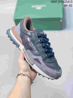 Side view of a black and gray Lacoste sneaker showing layered panels, branding and a rugged outsole.