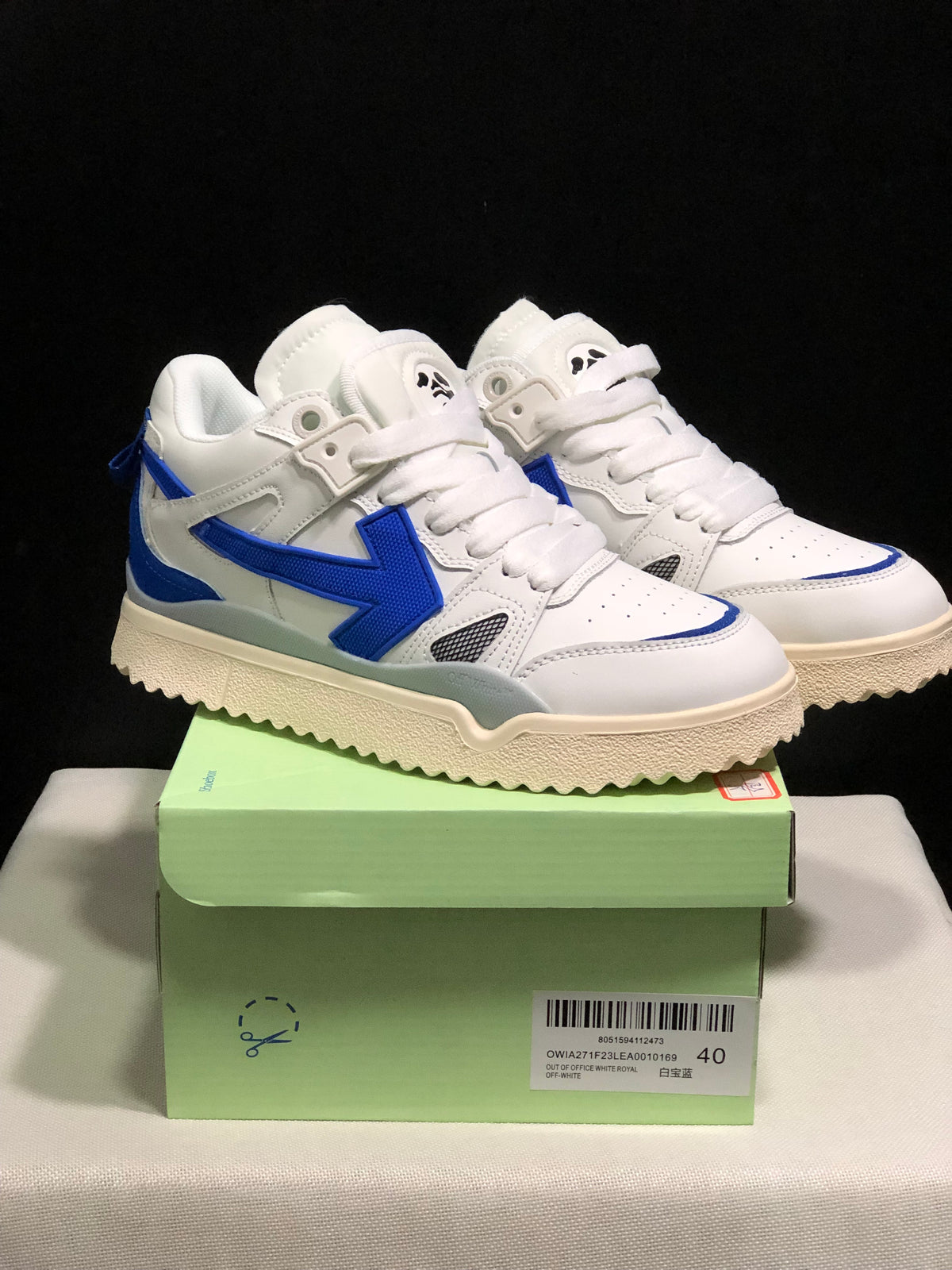 Pair of white and royal blue Off-White sneakers displayed on a green shoe box; the box label shows size 40 and identifies the Out Of Office model.