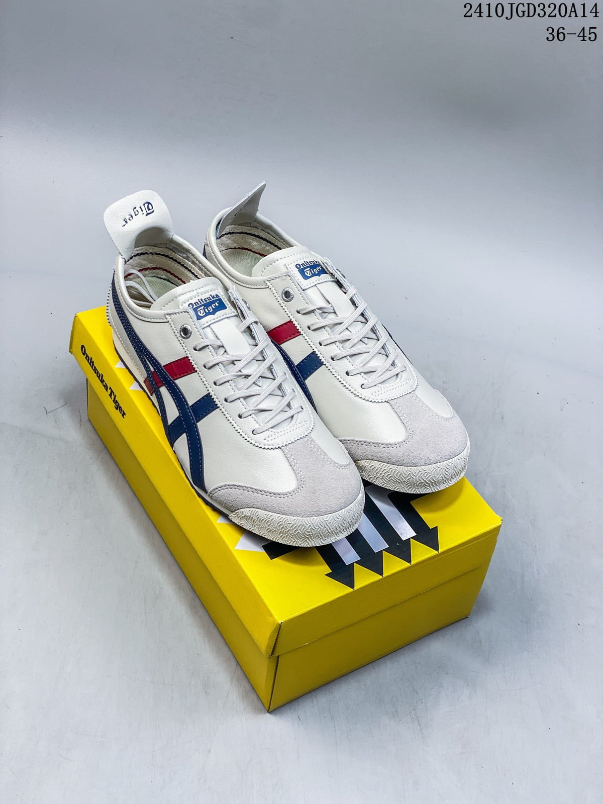 Pair of white Onitsuka Tiger Mexico 66 sneakers with blue and red stripes displayed on a yellow shoebox; style code 2410JGD320A14 and size range 36-45 are visible.