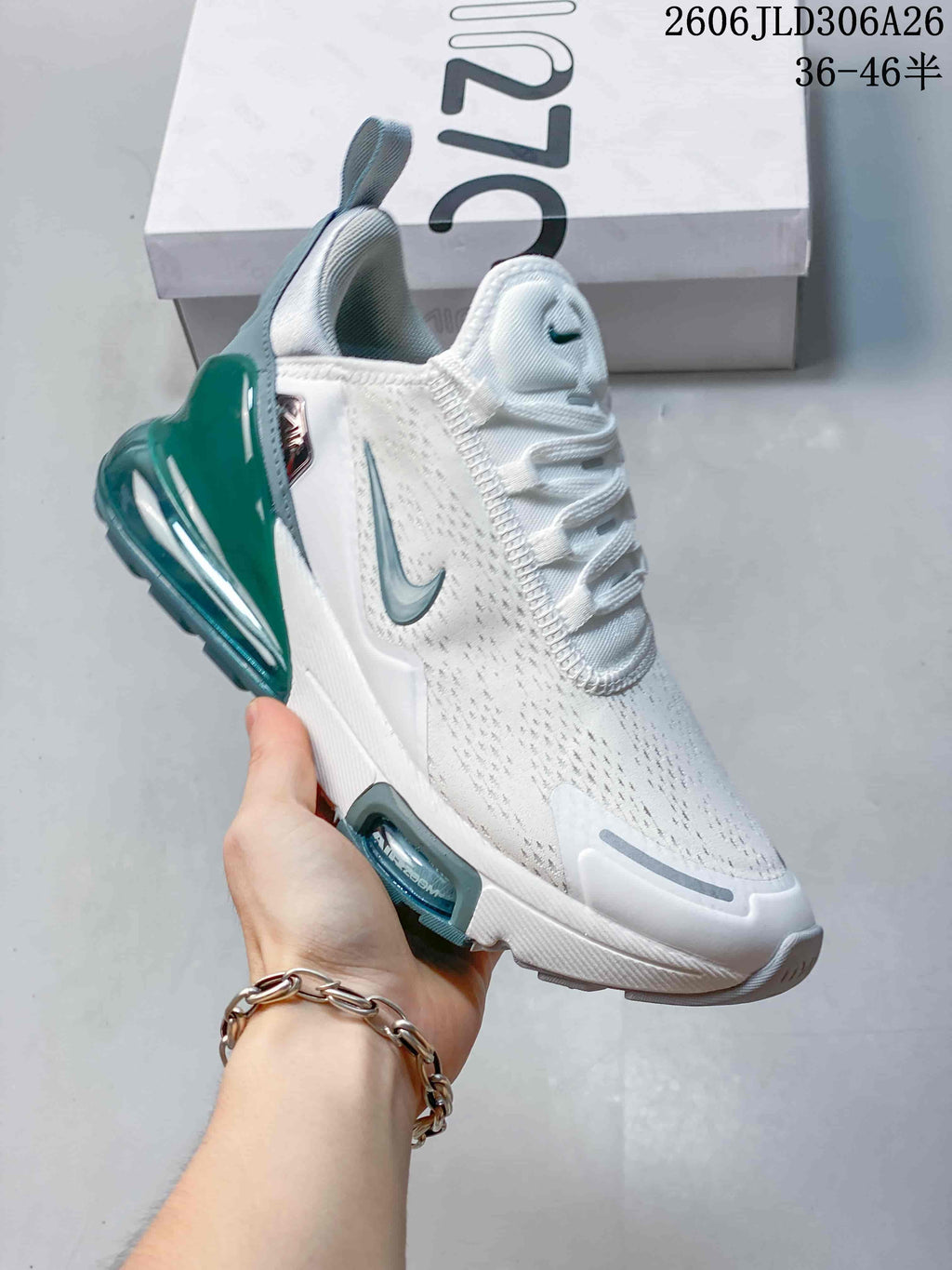 Angled side view of the white and teal Nike Air Max 270 sneaker