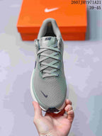 Top view showing the textured toe box, gray-green laces, padded tongue, and small navy Swoosh.