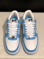 Close top view of the pair showing the blue and white panels, padded collars, white laces, and BAPE STA tongue labels.