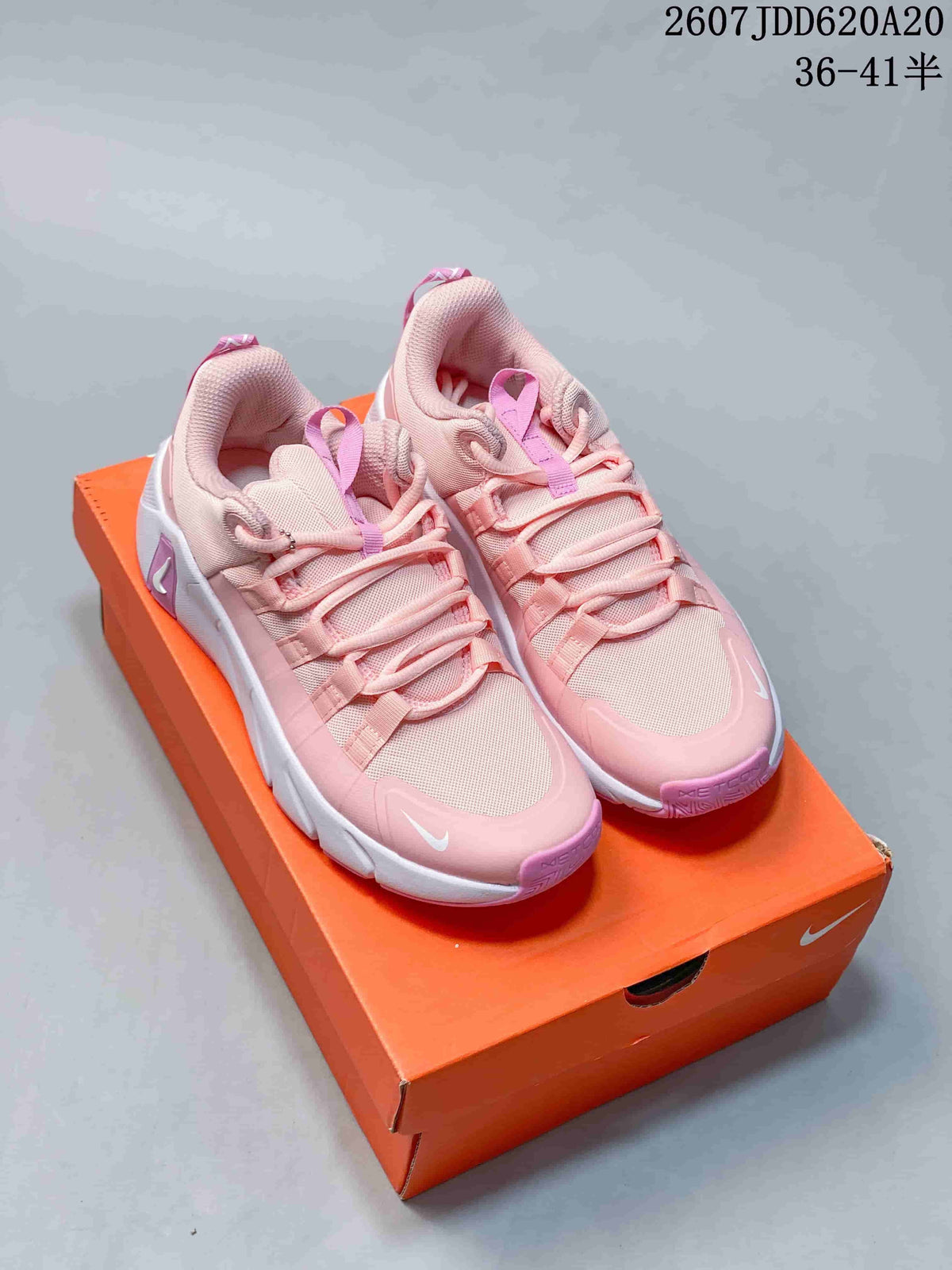 Pair of pink and white Nike Free Metcon 7 training shoes displayed on an orange shoe box, with style code JDD620A20 and a 36–41.5 size range shown above.