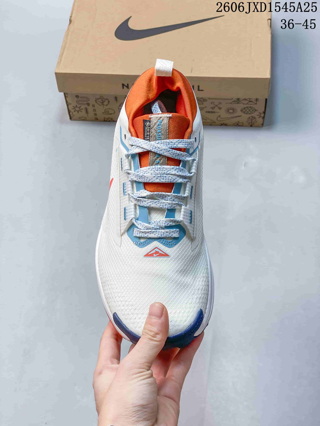 Top view of the trail shoe showing its patterned laces, orange tongue and blue details