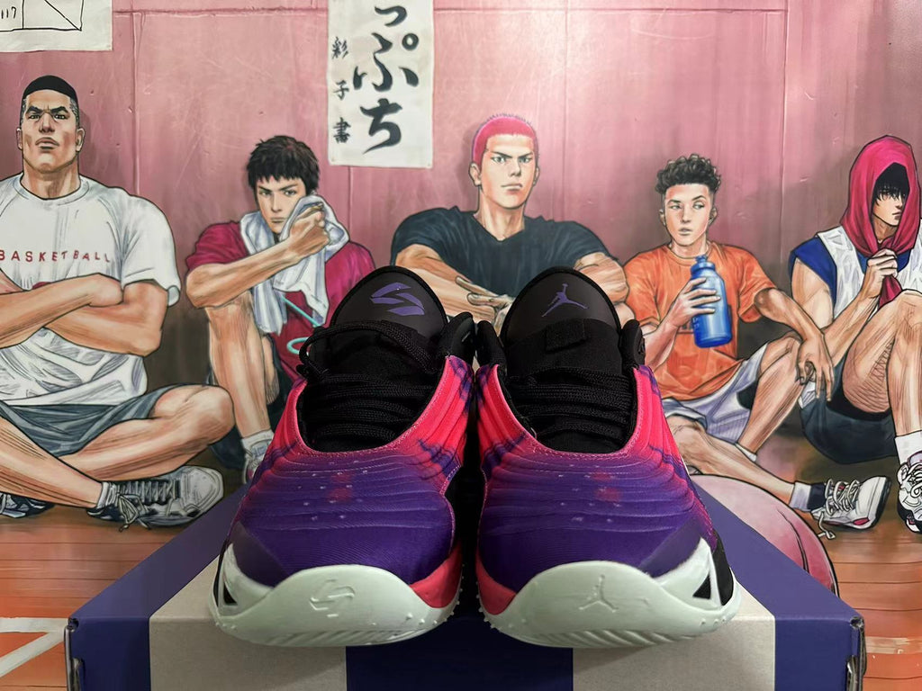 Front view of purple and pink Jordan Tatum basketball shoes with black laces and pale green toe accents.