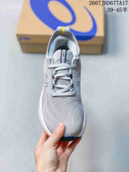 Top view of the gray running sneaker showing the textured toe box, lace-up closure, tongue, and padded collar.