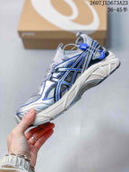 Side view of the sneaker showing layered ASICS branding, blue accents, mesh panels, and the sculpted midsole.