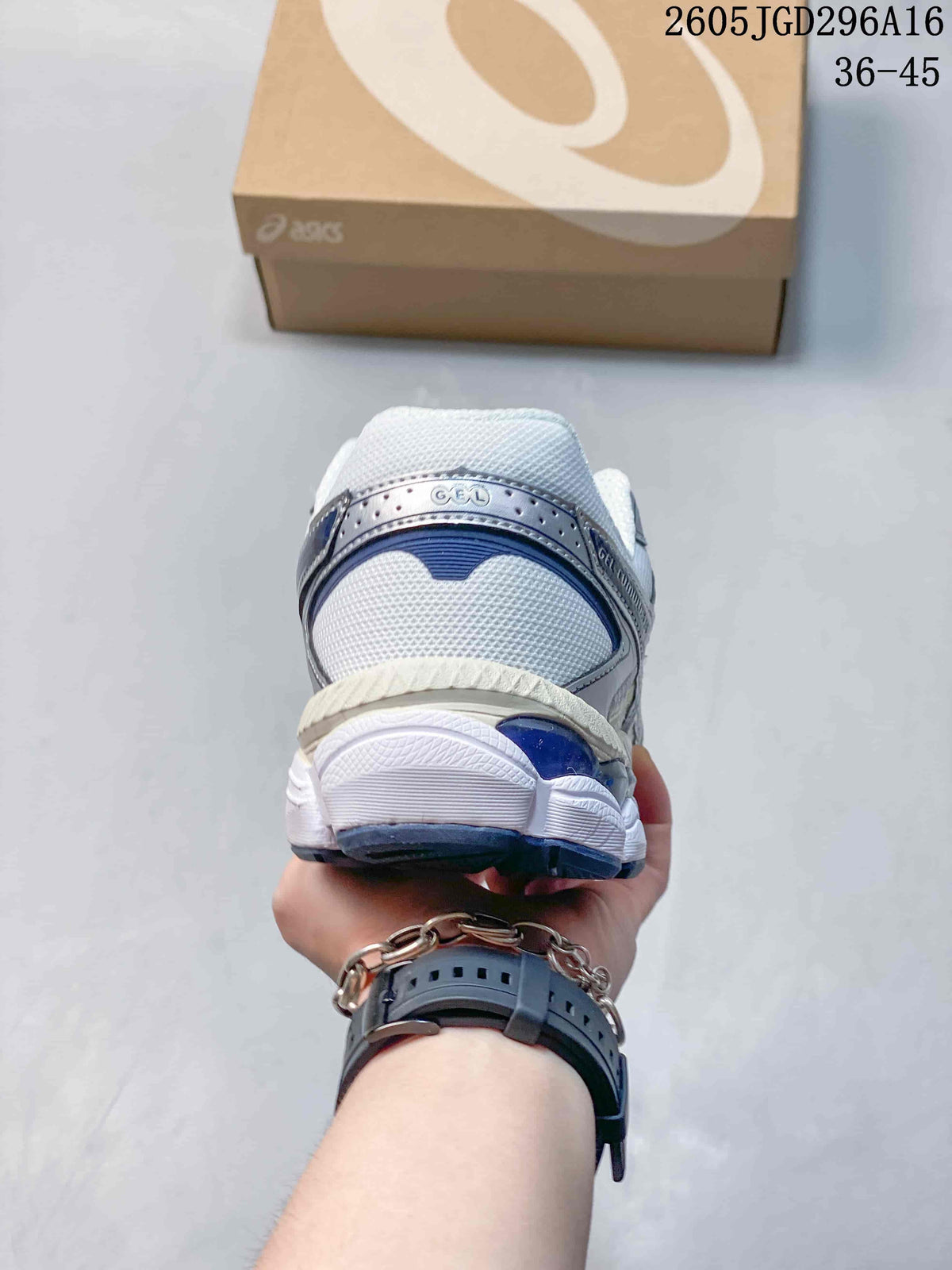 Rear view of a white, silver, and navy ASICS Gel-Cumulus 16 sneaker.