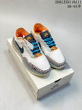 Pair of Nike SB PS8 sneakers displayed on a Nike SB shoebox, showing the white upper, blue laces, orange lining and patterned overlays.