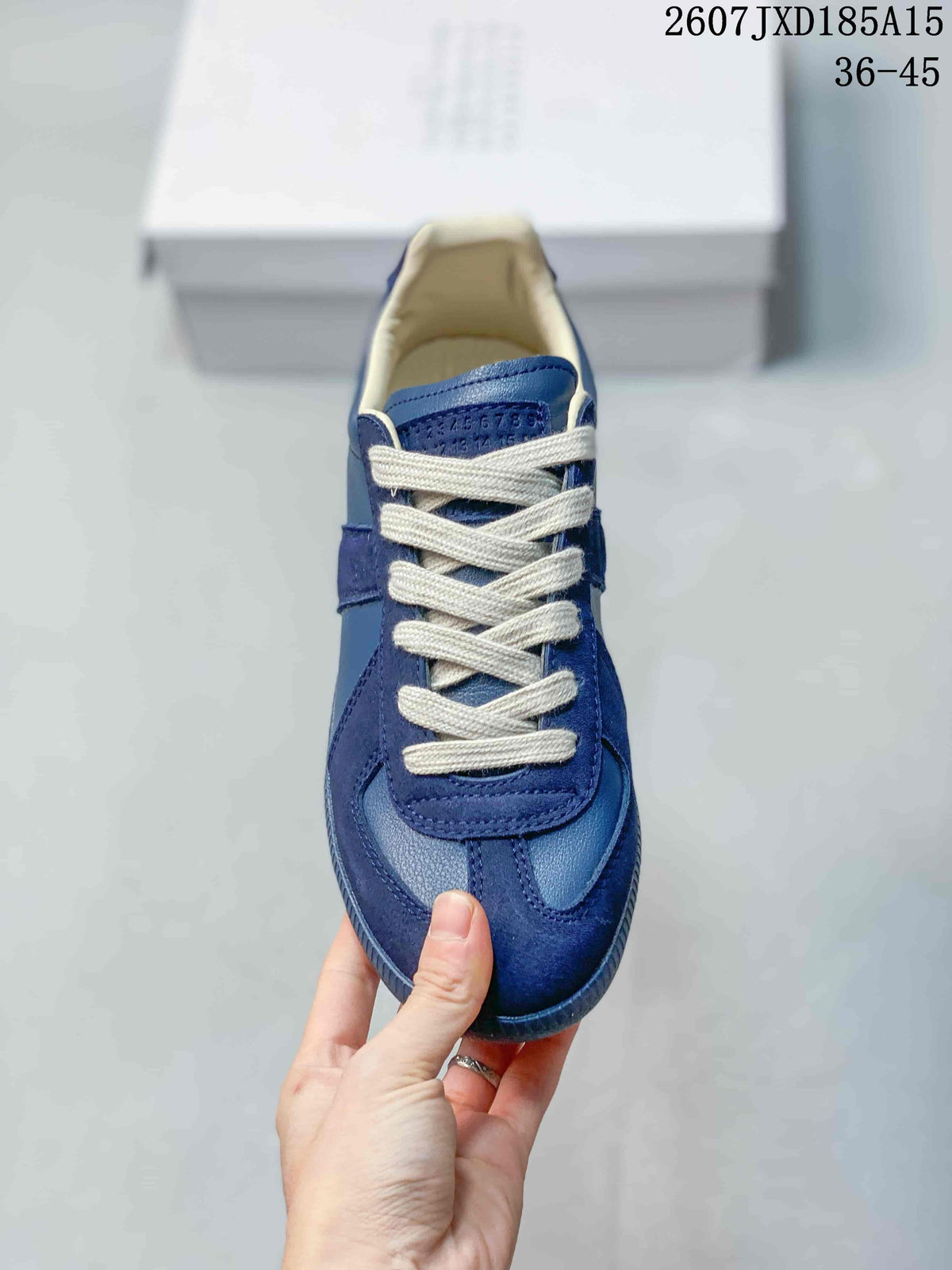 Top view of the blue sneaker showing white laces, layered toe panels, and cream-colored interior lining.