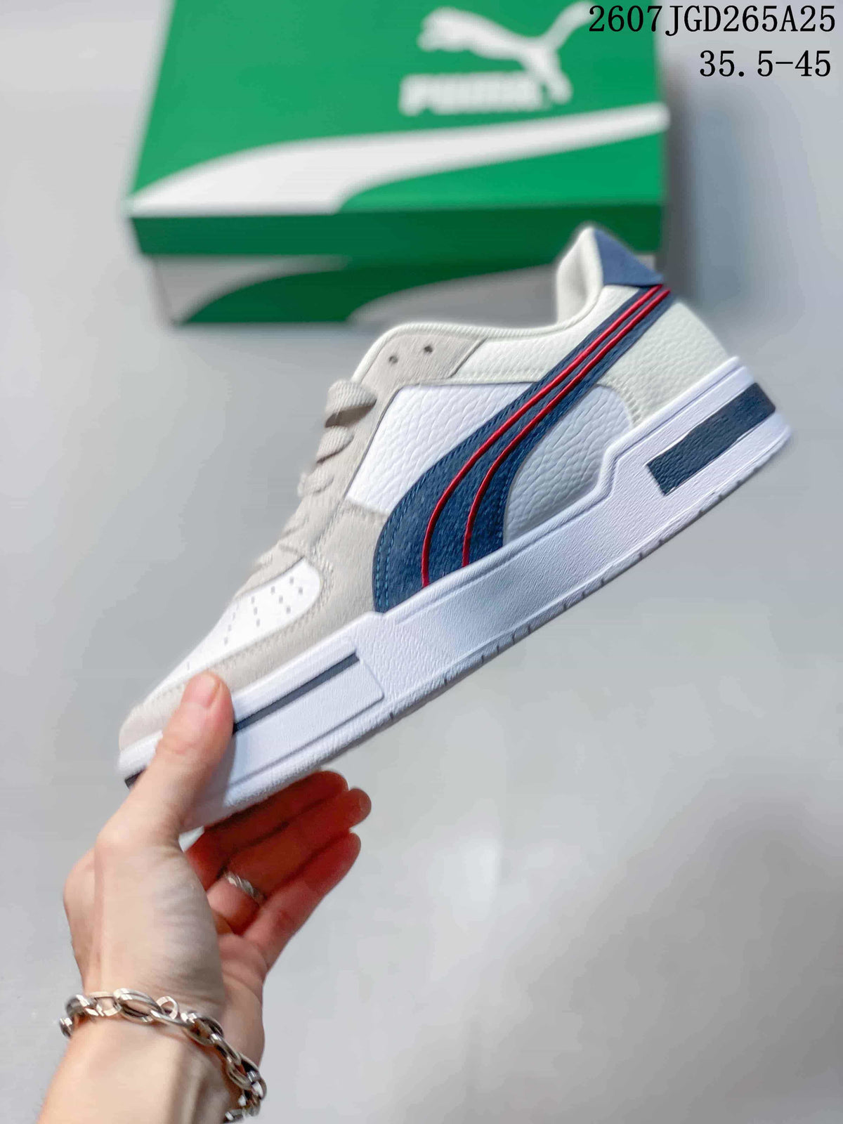 Side profile of the white low-top sneaker with navy and red side stripes and a layered white outsole.