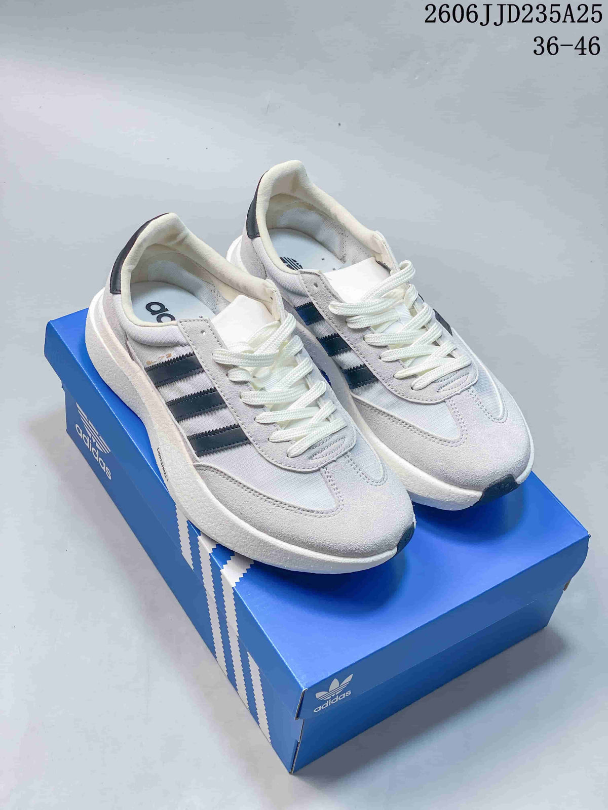 Light-colored Adidas Adizero SL 72 Pro sneakers with dark side stripes on a blue shoe box