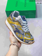 Angled view of the yellow, blue, silver-tone and white low-top sneaker