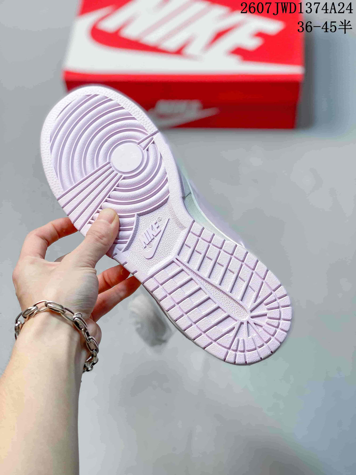 Underside view showing the patterned outsole of the pink and lilac sneaker.