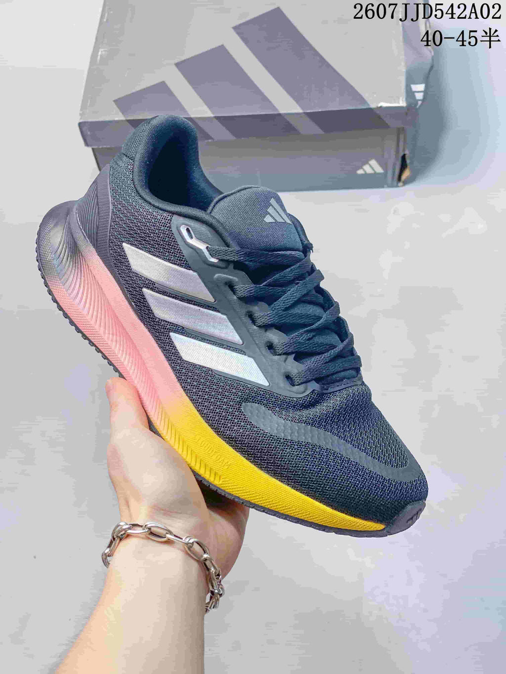 Dark gray adidas Runfalcon 5 shoe with bright yellow and pink accents on the sole.