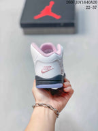 Rear view showing pink heel branding, padded collar lining, and the black outsole edge.