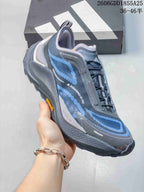 Angled side view of the gray and blue trail running shoe