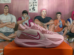Side view highlighting the dark pink Swoosh and layered pink panels.