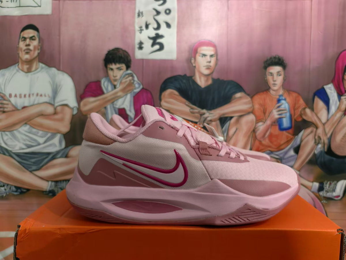 Side view highlighting the dark pink Swoosh and layered pink panels.